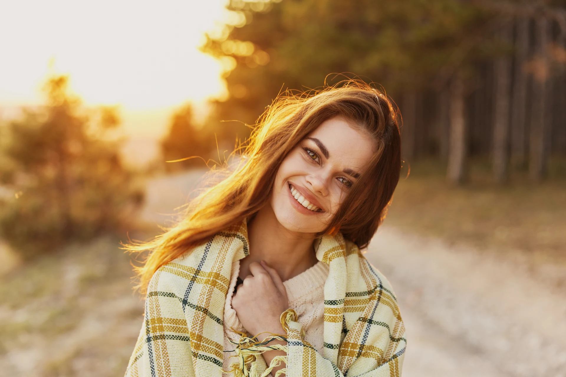 Woman smiling at the camera in warm sunset light